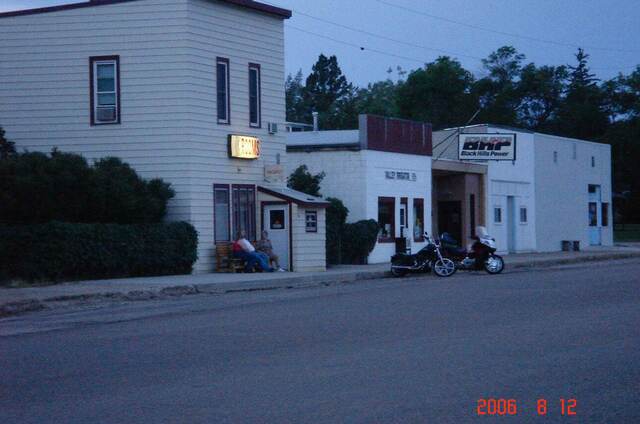 Moore's Rooms boarding house at dusk in Newell, South Dakota, with motorcycles parked out front