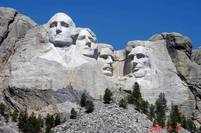 The four presidential faces of Mount Rushmore carved into the granite cliff face