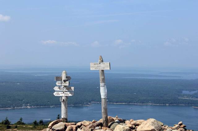 Trail signs atop Sargent Mountain, with Somes Sound and the surrounding hills spread out below