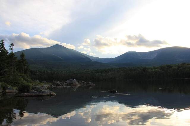 Mount Katahdin reflected in a still lake at dusk, seen from Baxter State Park