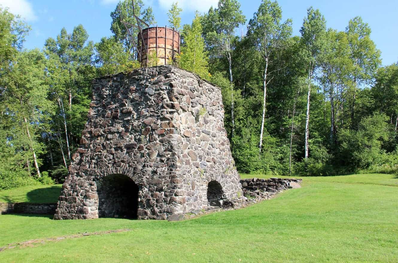 One of the stone kilns at Katahdin Iron Works, rising above the surrounding forest