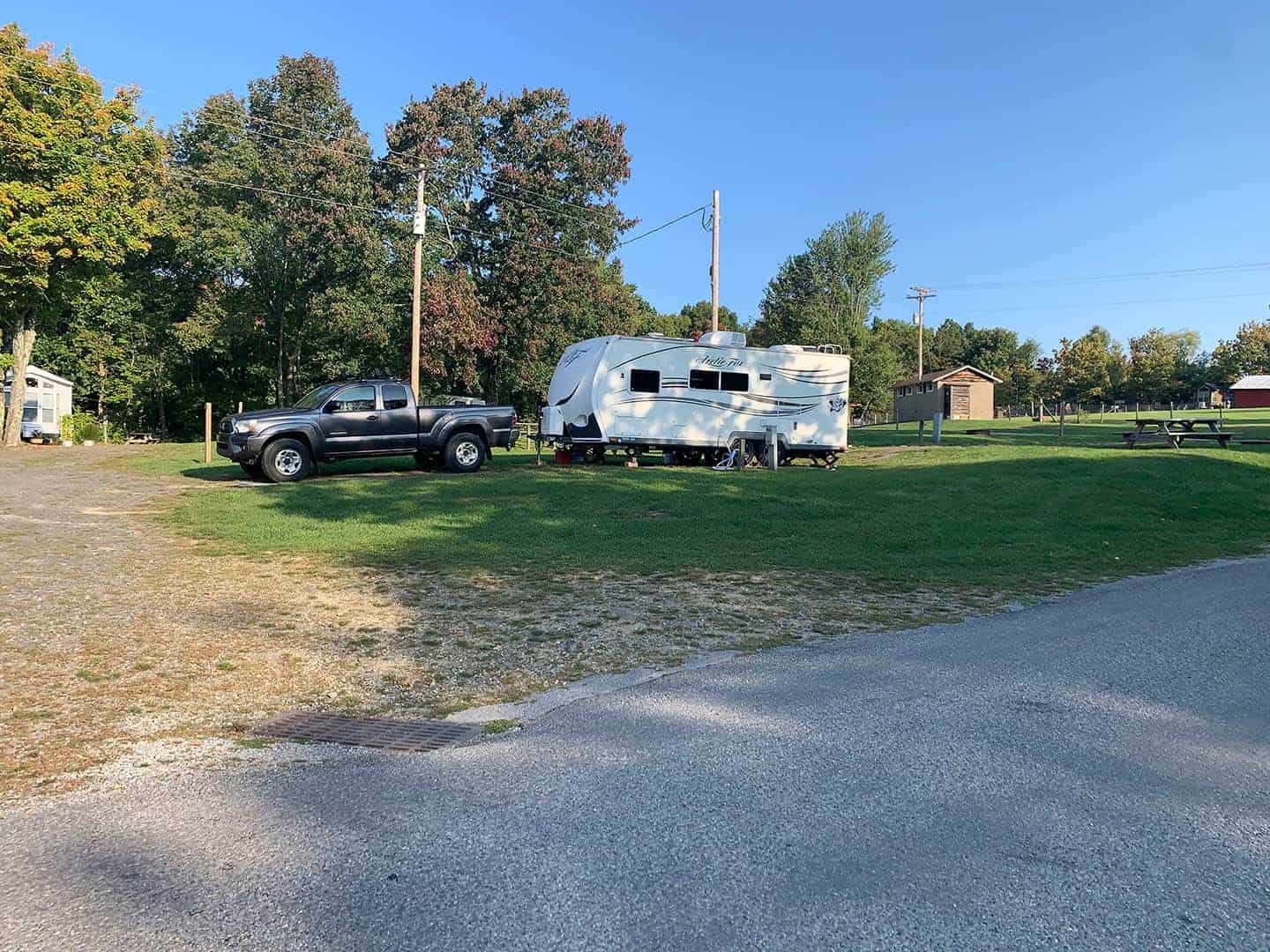 The truck and RV parked at the campsite at Pleasant Acres Farm RV Resort