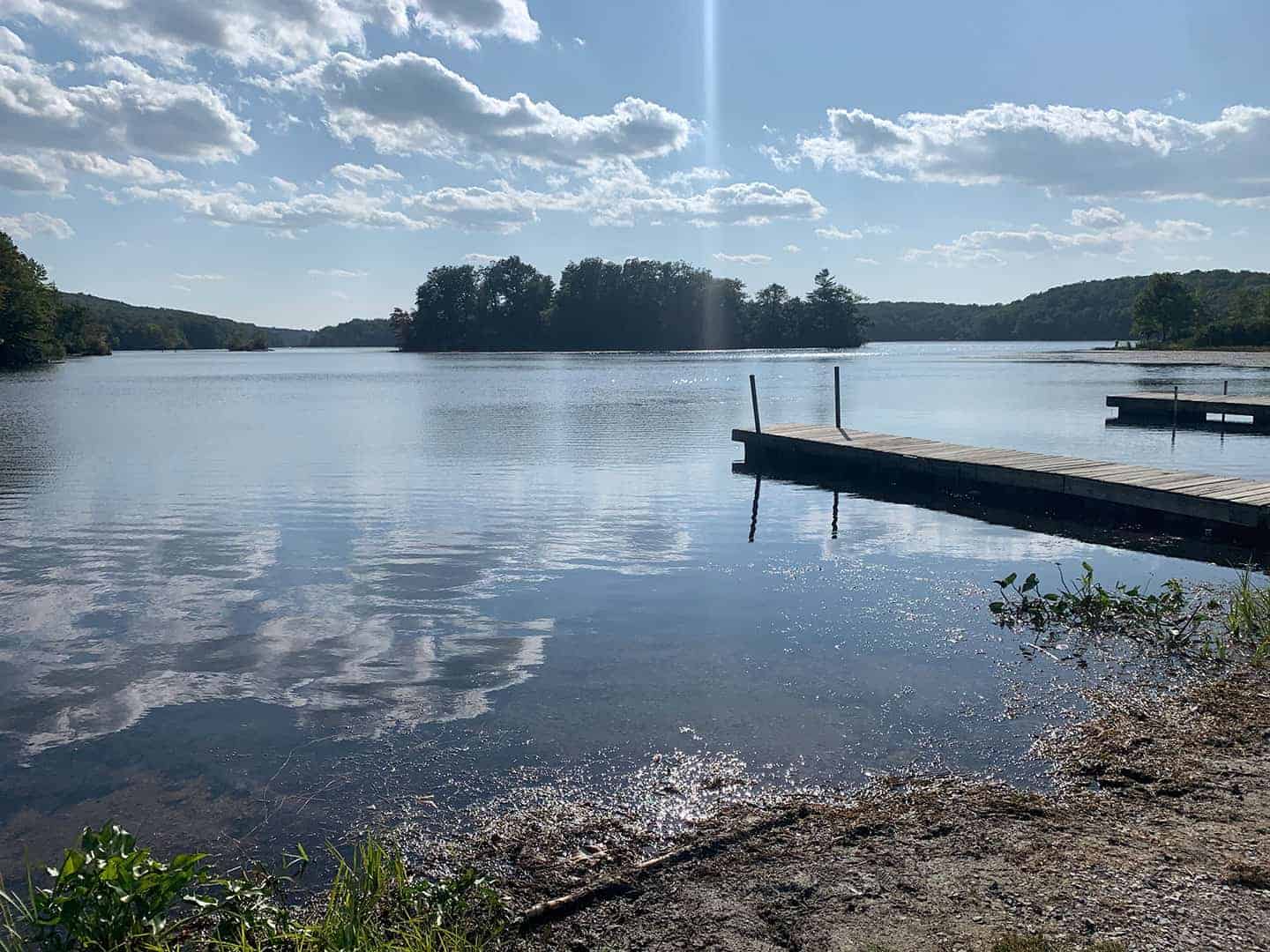 A dock reaching out into the lake at Wawayanda State Park, with a small island beyond