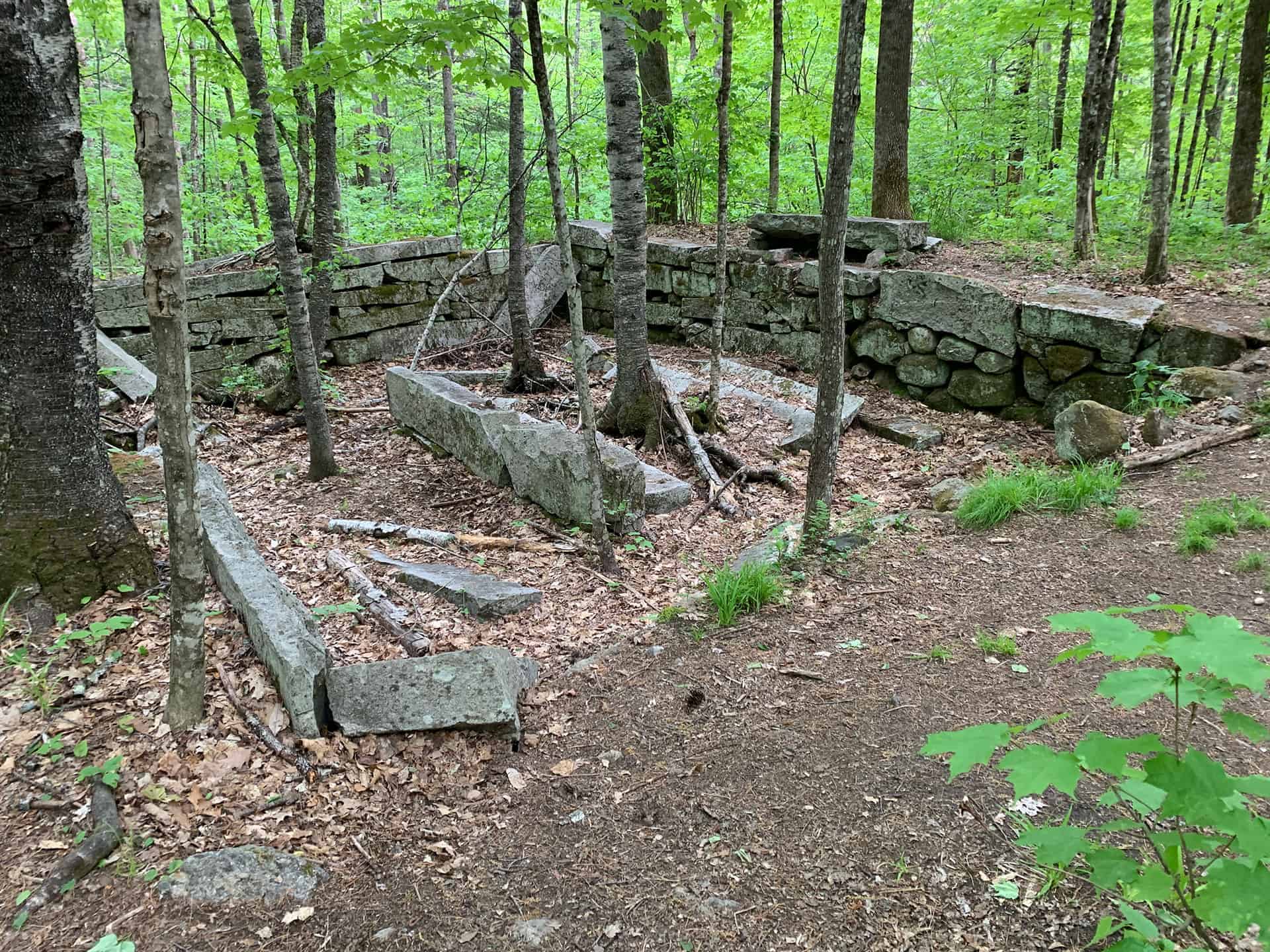 A narrow granite gorge with a small waterfall and deep pool at Sculptured Rocks