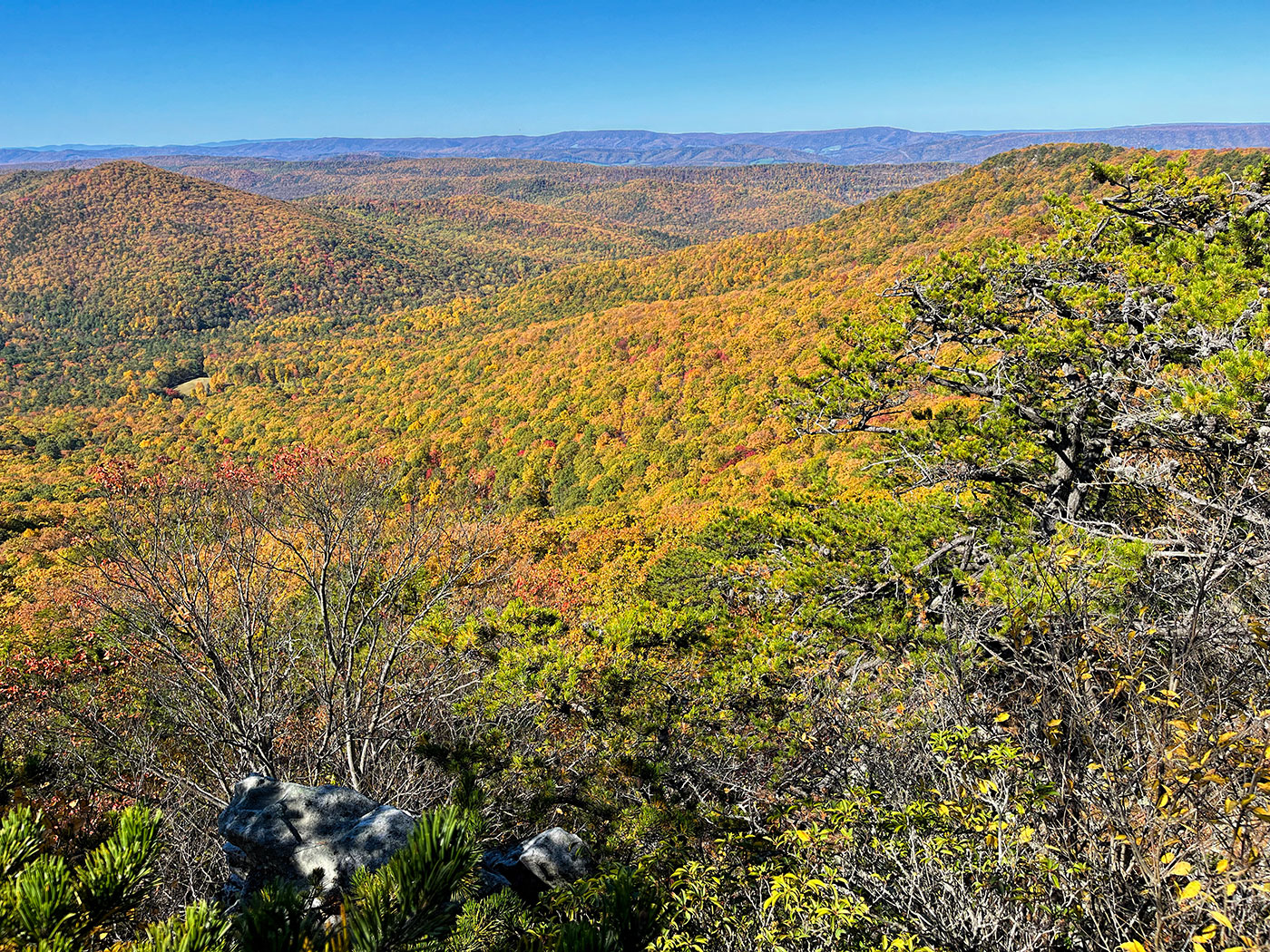 Rocky outcrops overlooking rolling ridges in fall color
