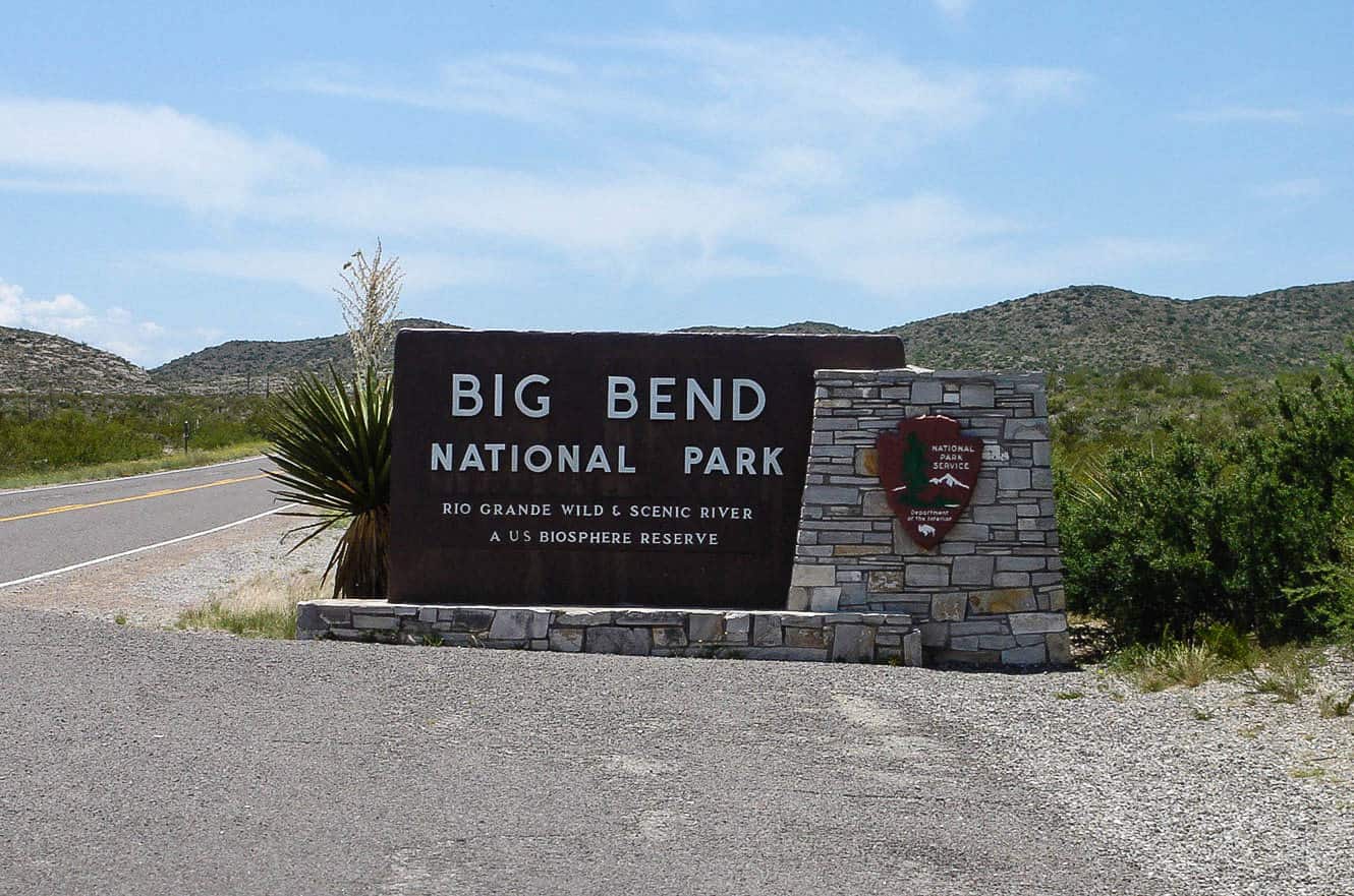 The Big Bend National Park entrance sign along a desert highway