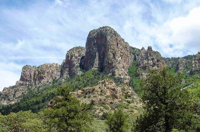 A dramatic rock tower rising above the Chisos Mountains in Big Bend National Park