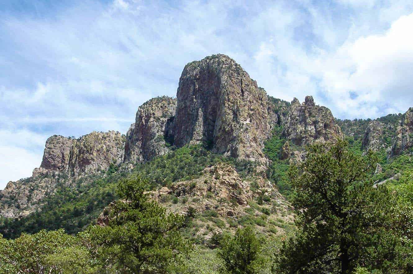 A dramatic rock tower rising above the Chisos Mountains in Big Bend National Park