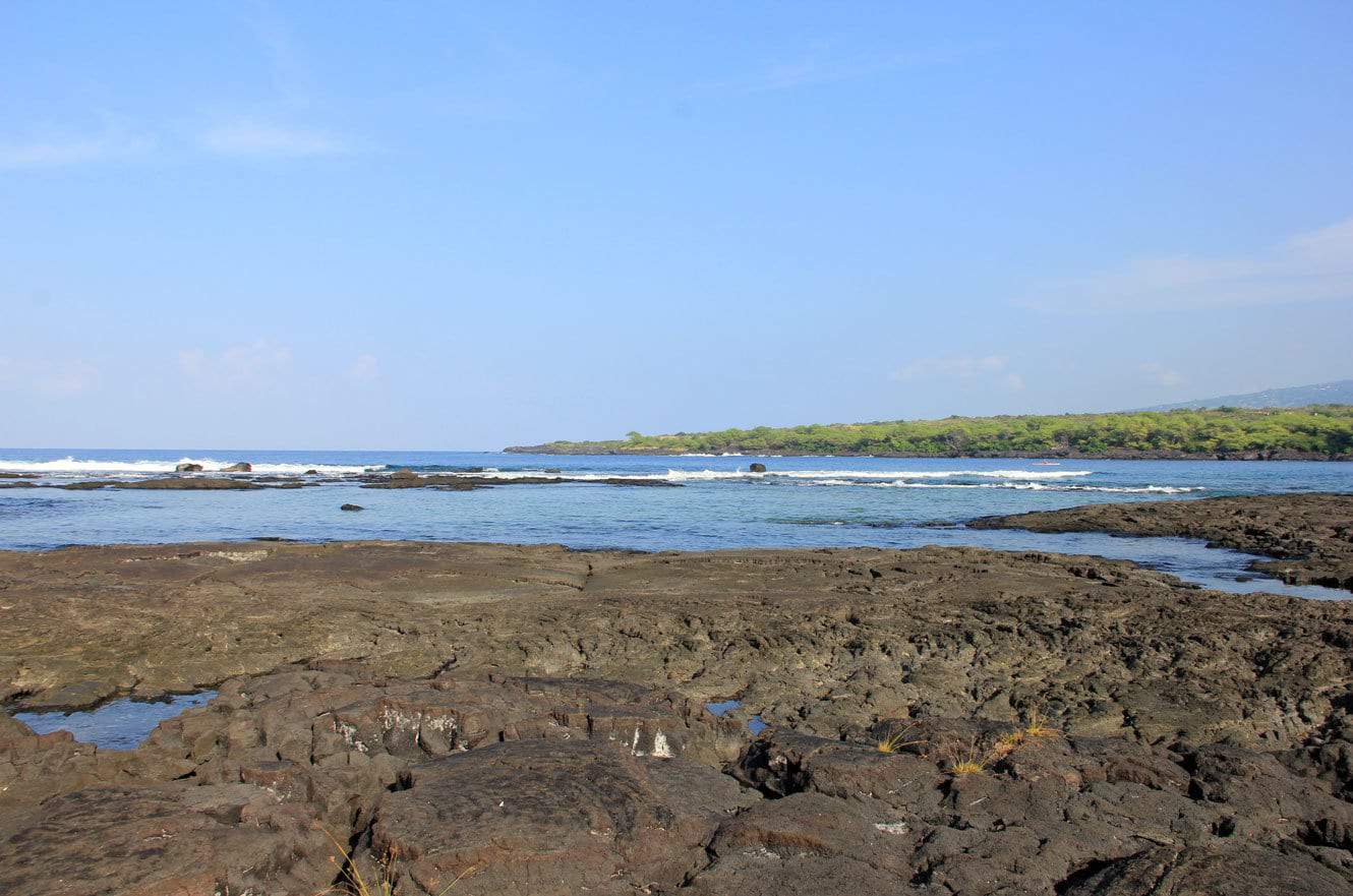 Rocky lava shoreline and tide pools stretching along the coast