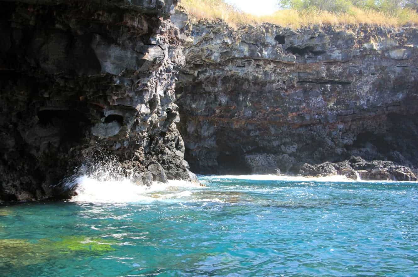 Waves crashing at the entrance of a lava sea cave