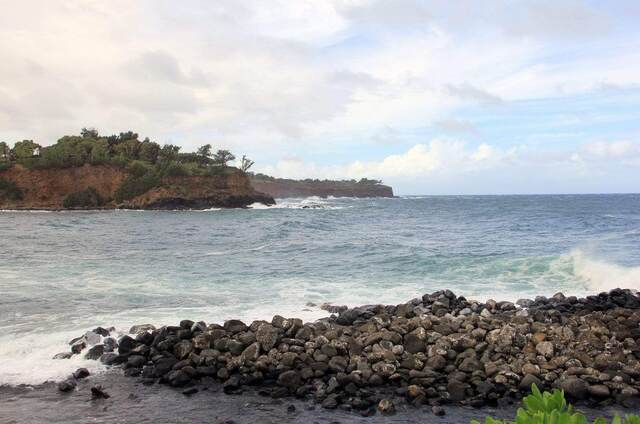 A rocky point and cliffs with waves crashing along the shoreline
