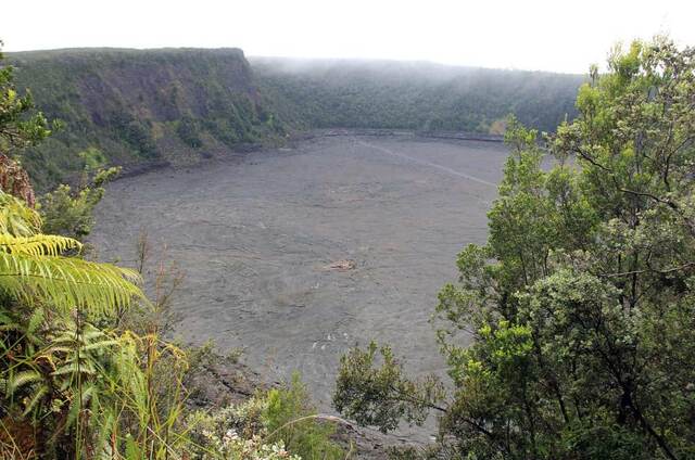 View down into the Kilauea Iki crater floor from the rim trail, ringed by forested cliffs