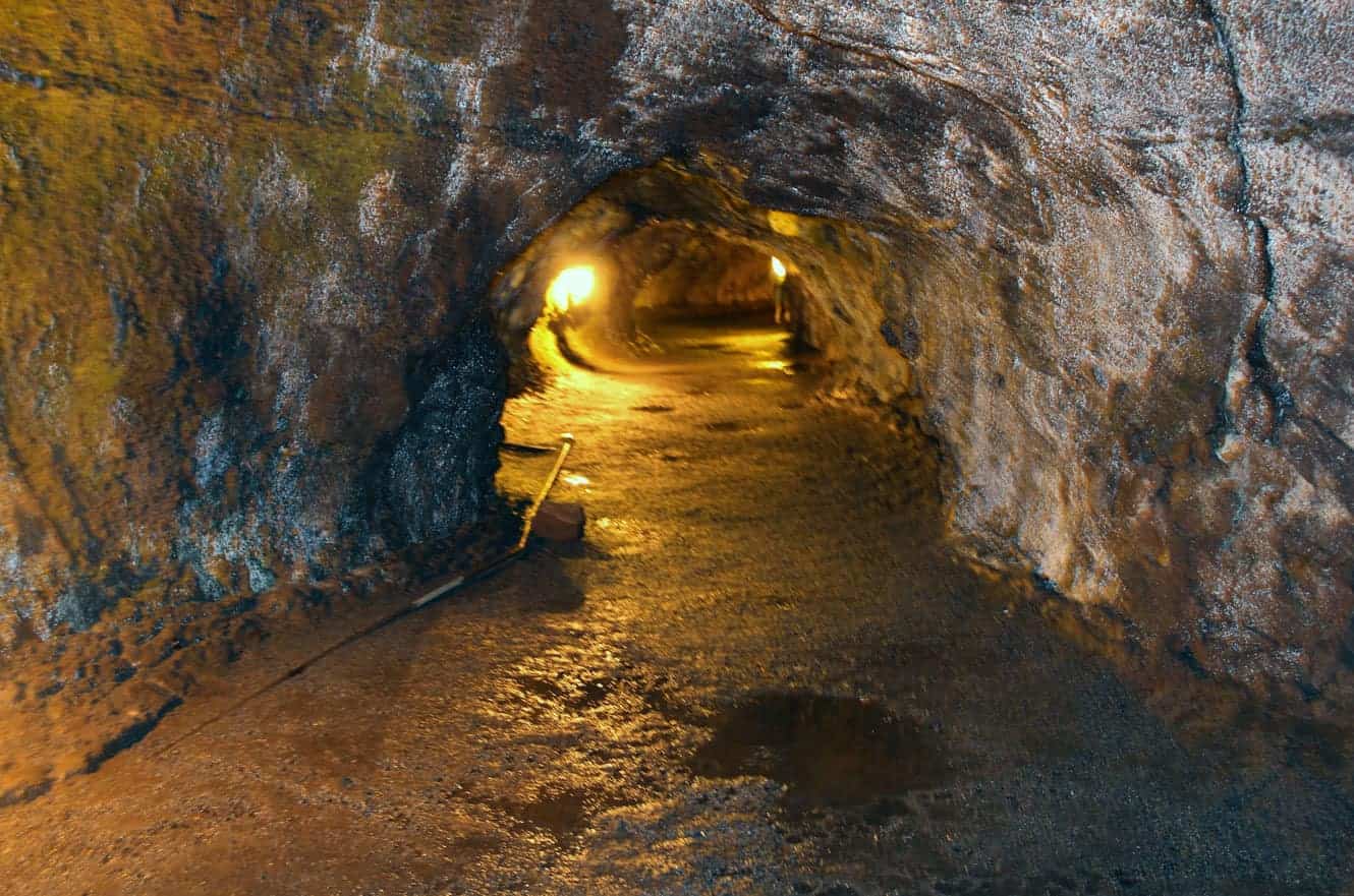 Inside the illuminated Thurston Lava Tube, the tunnel curving ahead