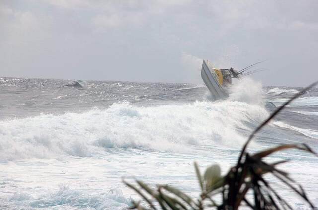 The boat nearly flipping backward as it launches off a large breaking wave