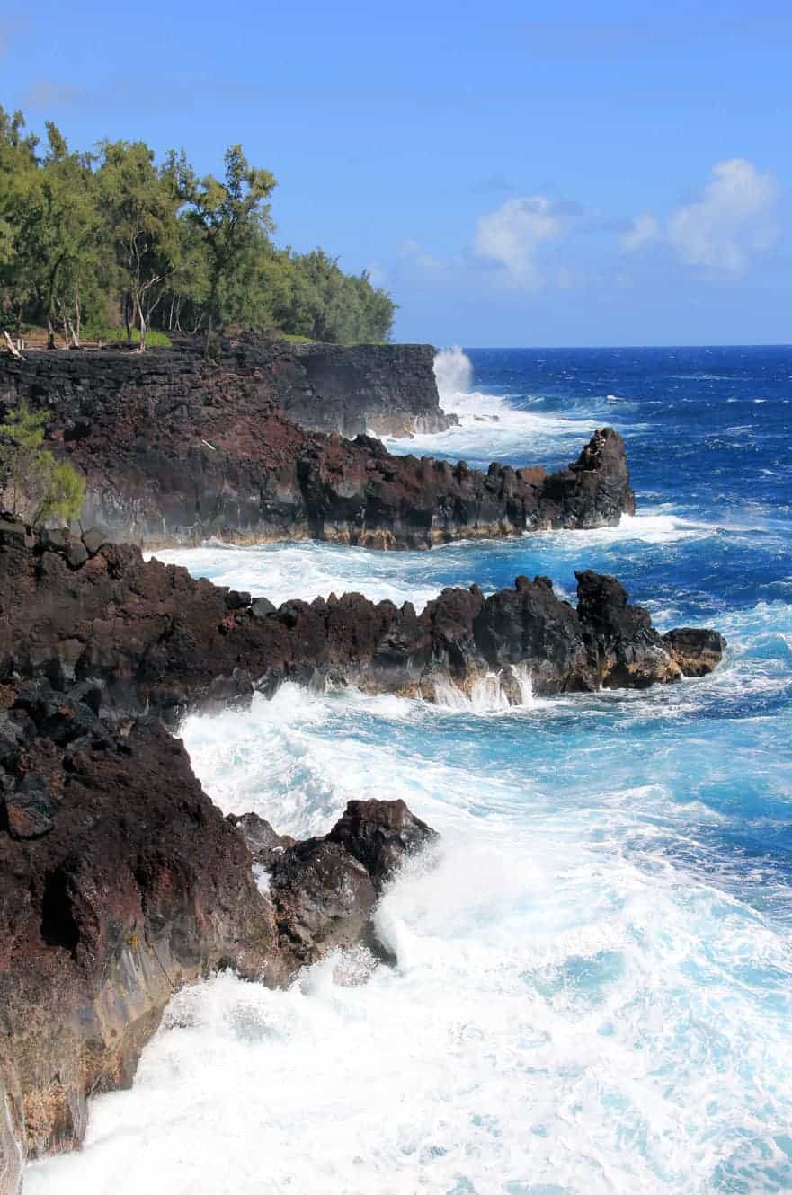 Waves crashing against lava sea cliffs at Isaac Hale Park