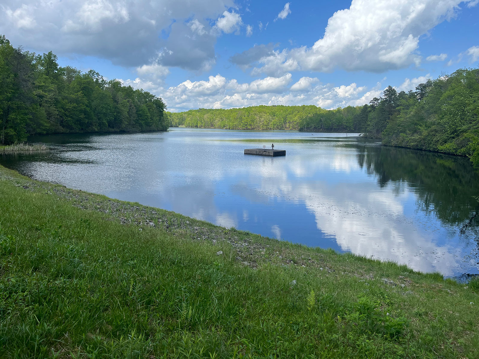 Lake Keokee with a small floating dock reflecting the clouds