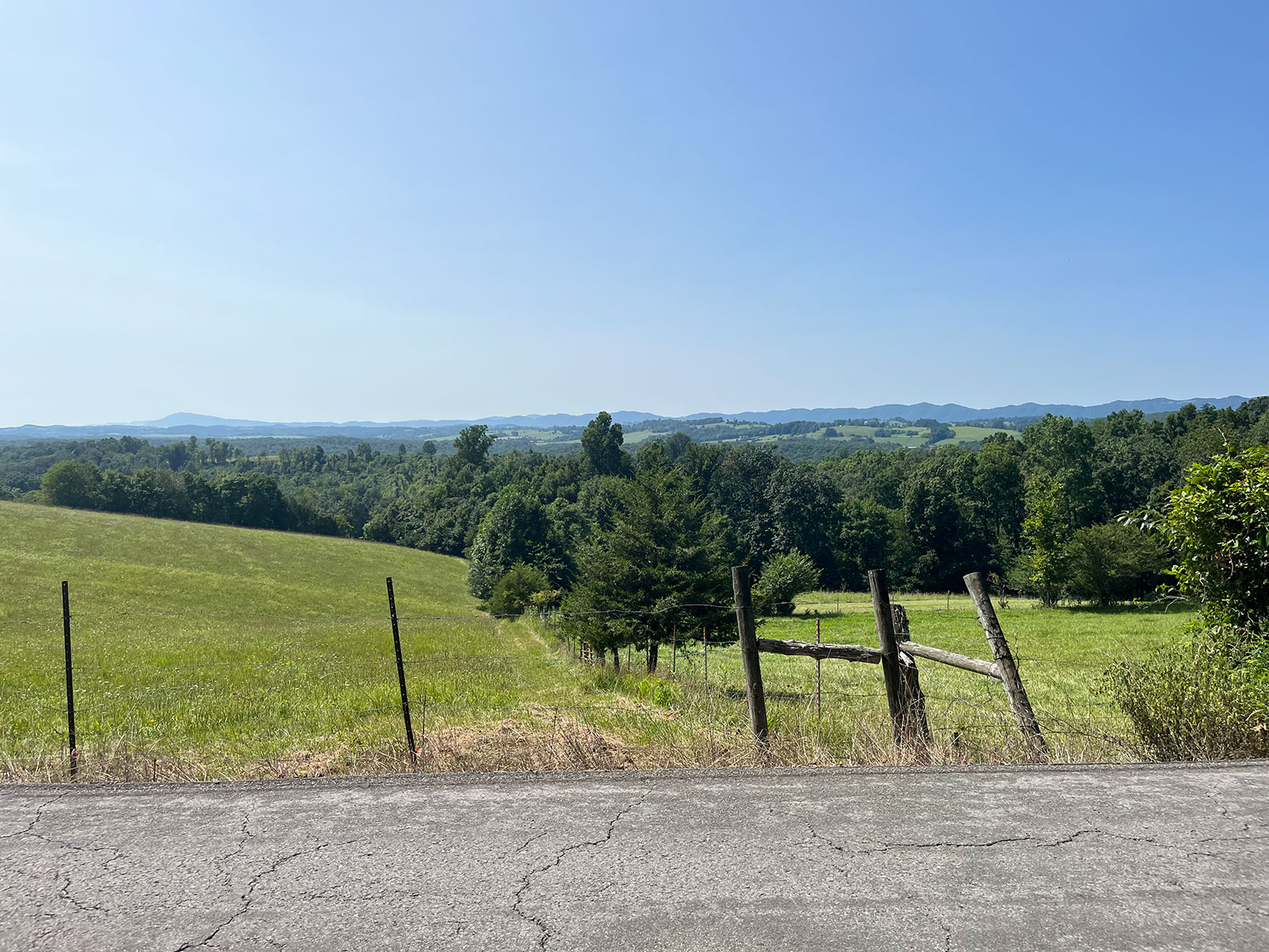 A pasture and mountain view along the roadside during the ride
